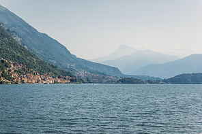 view of mountain lake and hills on shore with buildings during daytime, Lake Como, Italy