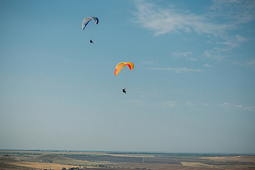 Parachutes in the sky over field in hillside area of Crimea, Ukraine, May 2013
