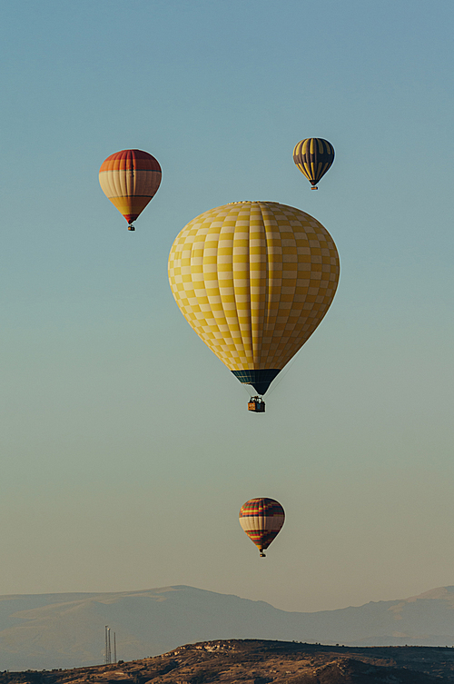 Hot air balloons festival in blue sky in Goreme national park, fairy chimneys, Cappadocia, Turkey