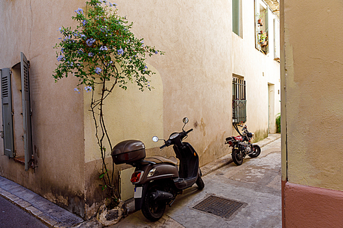 ANTIBES, FRANCE - 17 SEPTEMBER 2017: motorcycles parked on narrow street of old european town, Antibes, France