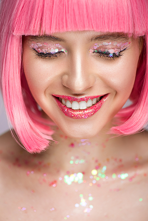 smiling attractive woman with pink hair and glitter on face