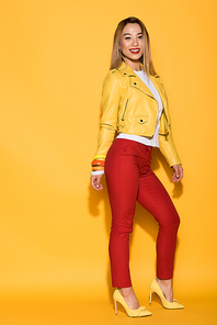 stylish asian female model posing on yellow background