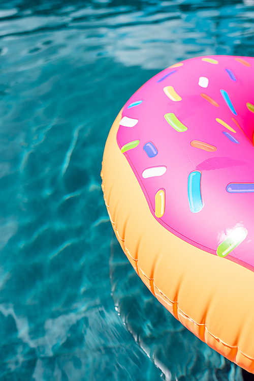 close-up shot of inflatable ring in shape of donut floating in swimming pool