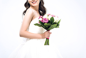 cropped shot of smiling young bride in wedding dress with bouquet isolated on white