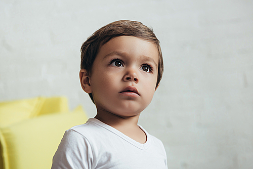 portrait of cute surprised boy at home