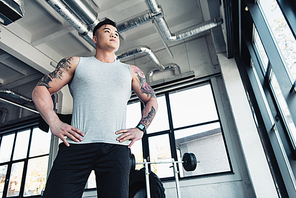low-angle shot of young sportsman at gym