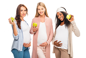 smiling pregnant women holding fruit in hands isolated on white
