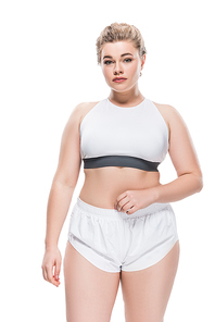 attractive overweight girl in sportswear looking at camera isolated on white