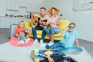 happy family holding passport, packing baggage for summer vacation and having great time, travel concept