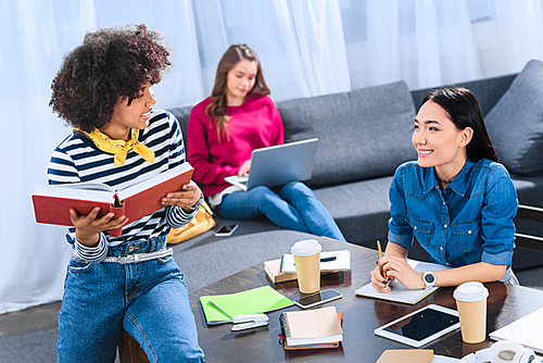 multicultural group of young students studying together