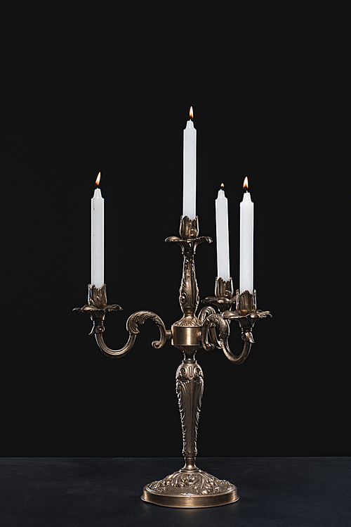 candelabrum with flaming candles on black background