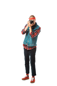 young hipster male photographer in denim vest and checkered shirt shooting on camera isolated on white