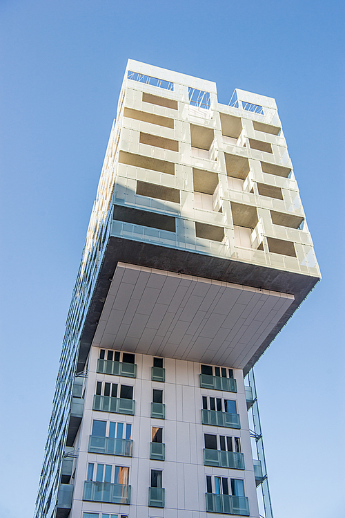 low angle view of beautiful modern building against blue sky at Barcode district, Oslo