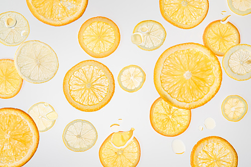 bright fresh orange and lemon slices on grey background