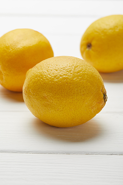 delicious ripe organic lemons on white wooden table