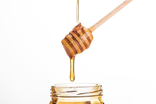 wooden honey dipper with dripping sweet honey isolated on white