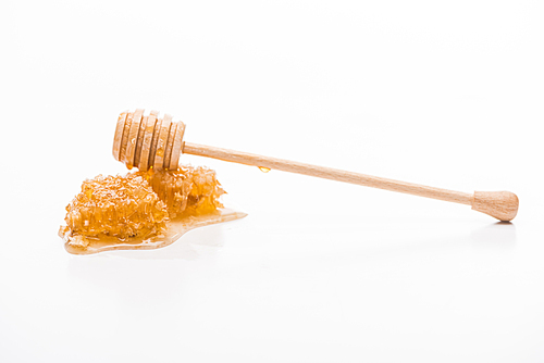 honeycomb with sweet honey and wooden honey dipper isolated on white