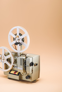 close up view of old film projector on beige background