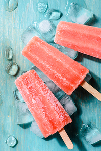 Sweet red fruit Popsicles on wooden background
