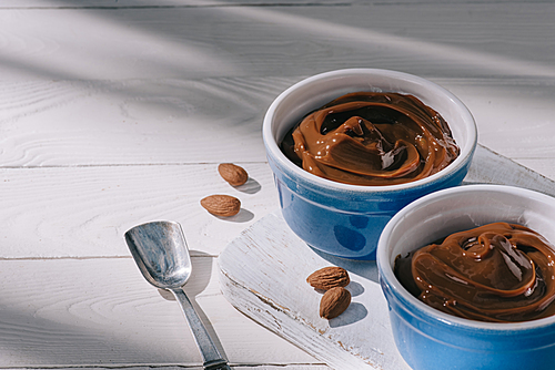 bowls with chocolate dessert on wooden board on table