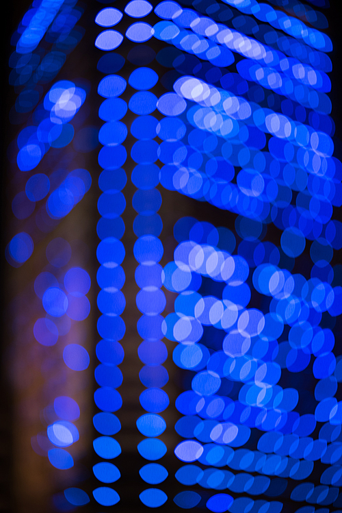 defocused city building with bokeh lights as background