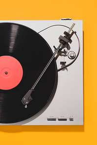 top view of retro vinyl player and record isolated on yellow