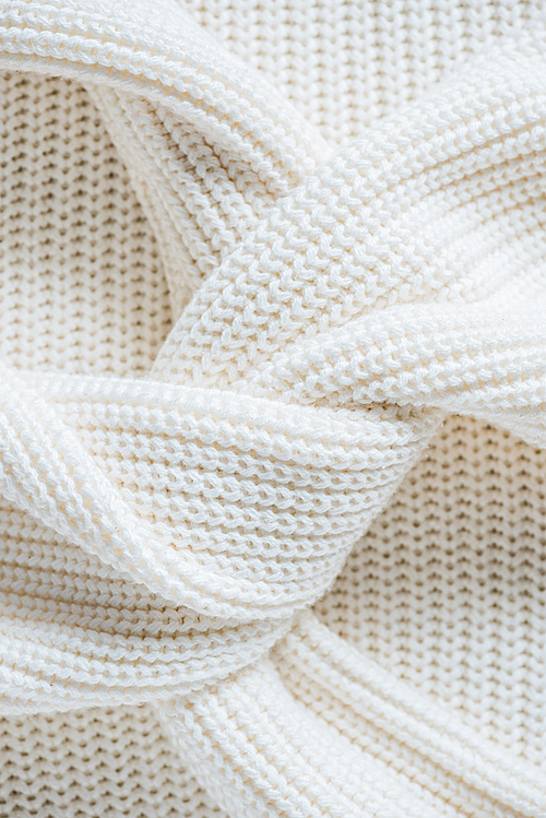 close up view of twisted sleeves of white woolen sweater