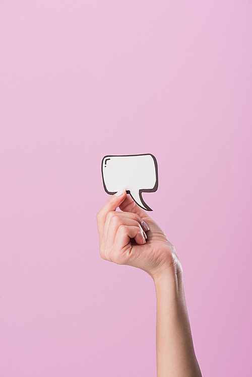 cropped shot of woman holding blank speech bubble isolated on pink