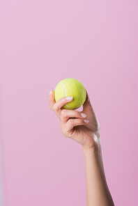 cropped shot of woman holding tennis ball isolated on pink