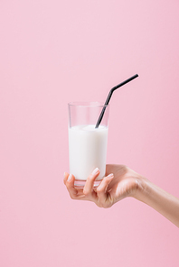 cropped shot of woman holding glass of milk isolated on pink