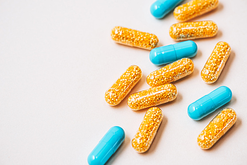 close-up shot of plastic medical capsules on white