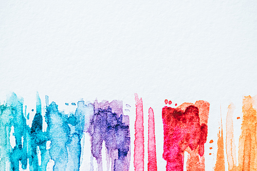 abstract colorful watercolor strokes on white paper background