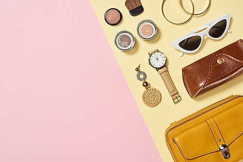 Flat lay with watch, earring, bag, case, sunglasses, blush, eyeshadow, bracelets and cosmetic brush