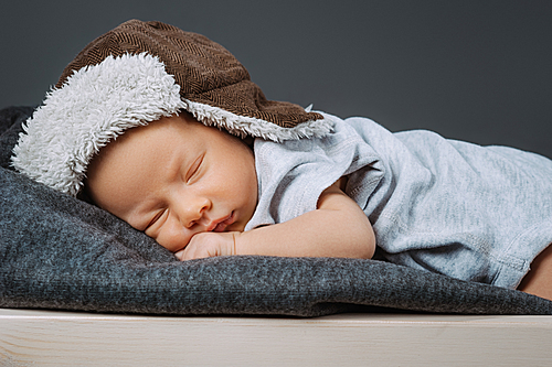 portrait of adorable sleeping newborn baby in hat