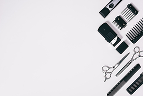 top view of arrangement of various barber tools isolated on grey