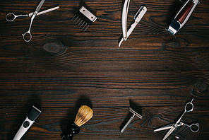 top view of arrangement of various barber tools on wooden tabletop