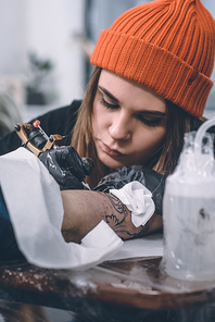 Professional tattooing process on arm piece