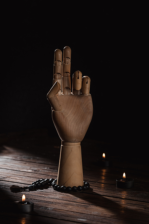 wooden hand with prana mudra gesture