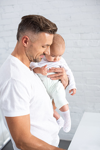 happy parent holding baby at home