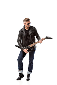 stylish adult man in leather jacket playing electric guitar isolated on white