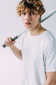 handsome man holding tennis racket isolated on grey