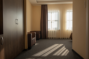 hotel room interior with wardrobe, armchairs and window