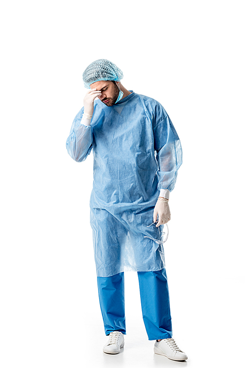 Upset surgeon wearing blue uniform isolated on white
