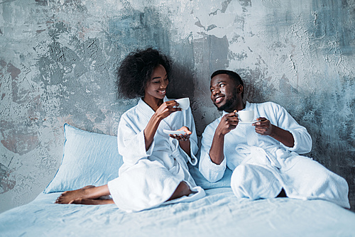 Young african american couple in bed with cups of coffee | 유토이미지 | 상세 ...