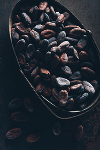 close-up view of delicious cocoa beans on dark surface