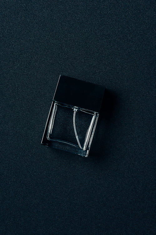 top view of bottle of aromatic perfume on black