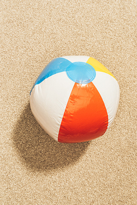 top view of colorful beach ball on sand
