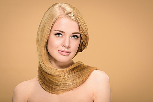 Front view of stunning girl with long hair on beige background