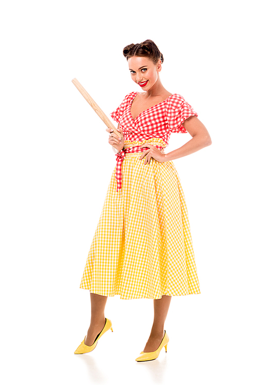 Smiling stylish pin up girl holding rolling pin and  isolated on white