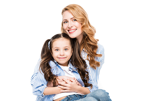 portrait of smiling mother hugging little daughter isolated on white